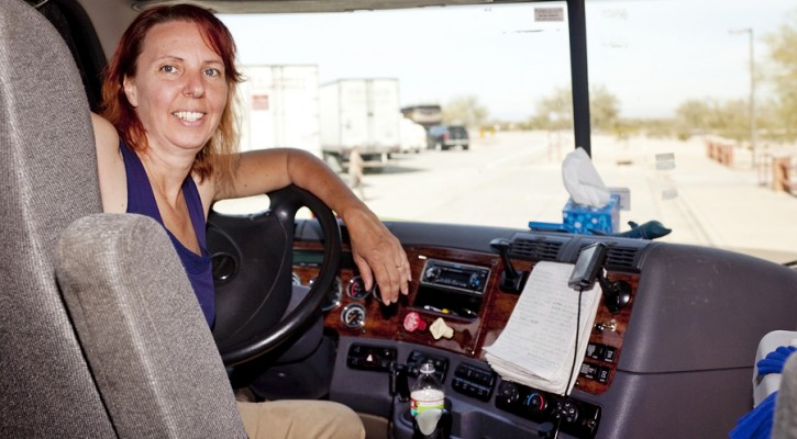 Woman Truck Driver At The Wheel