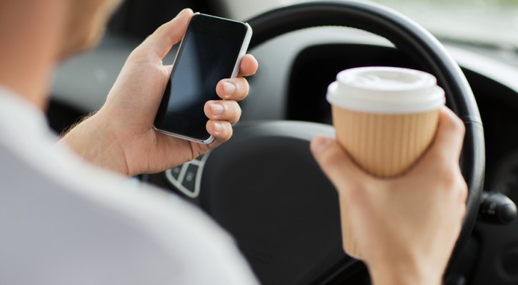 transportation and vehicle concept - man drinking coffee and usi